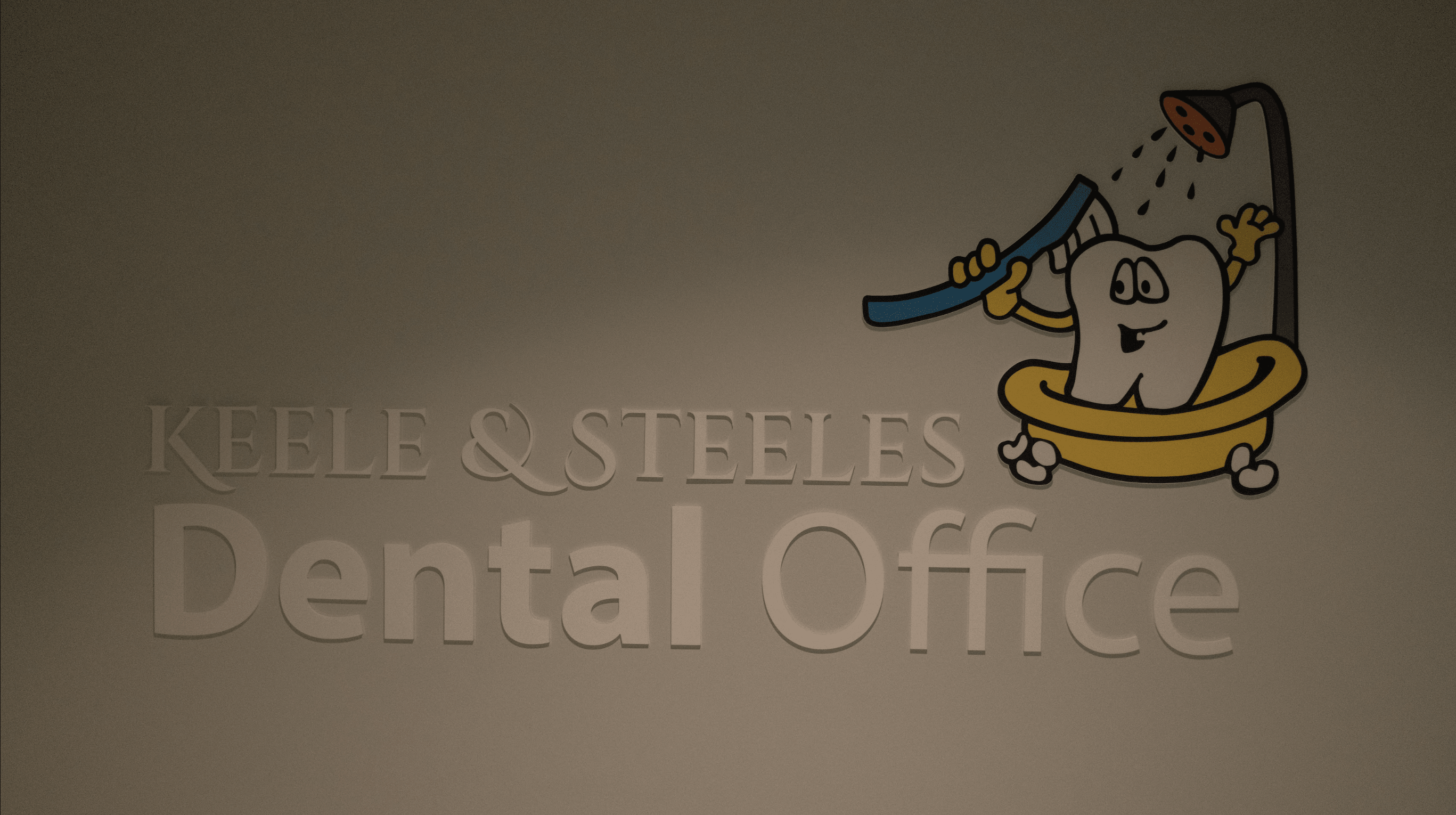 Keele & Steeles Dental Office wall sign with tooth mascot